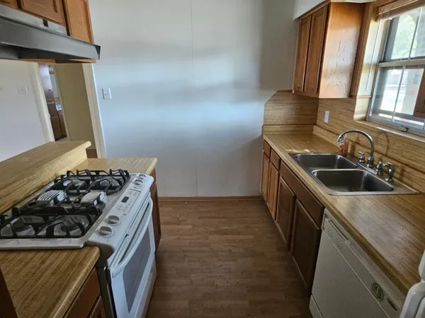 a kitchen that has a sink and a stove