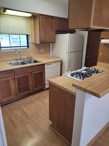 a kitchen with a sink appliances and cabinets