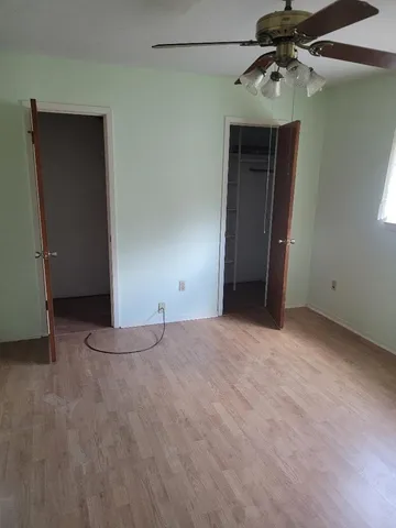 a view of an empty room with a ceiling fan