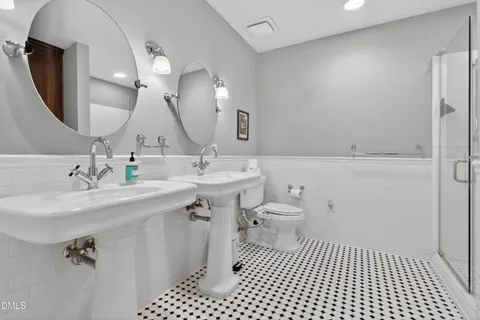 a bathroom with a sink a toilet and a mirror