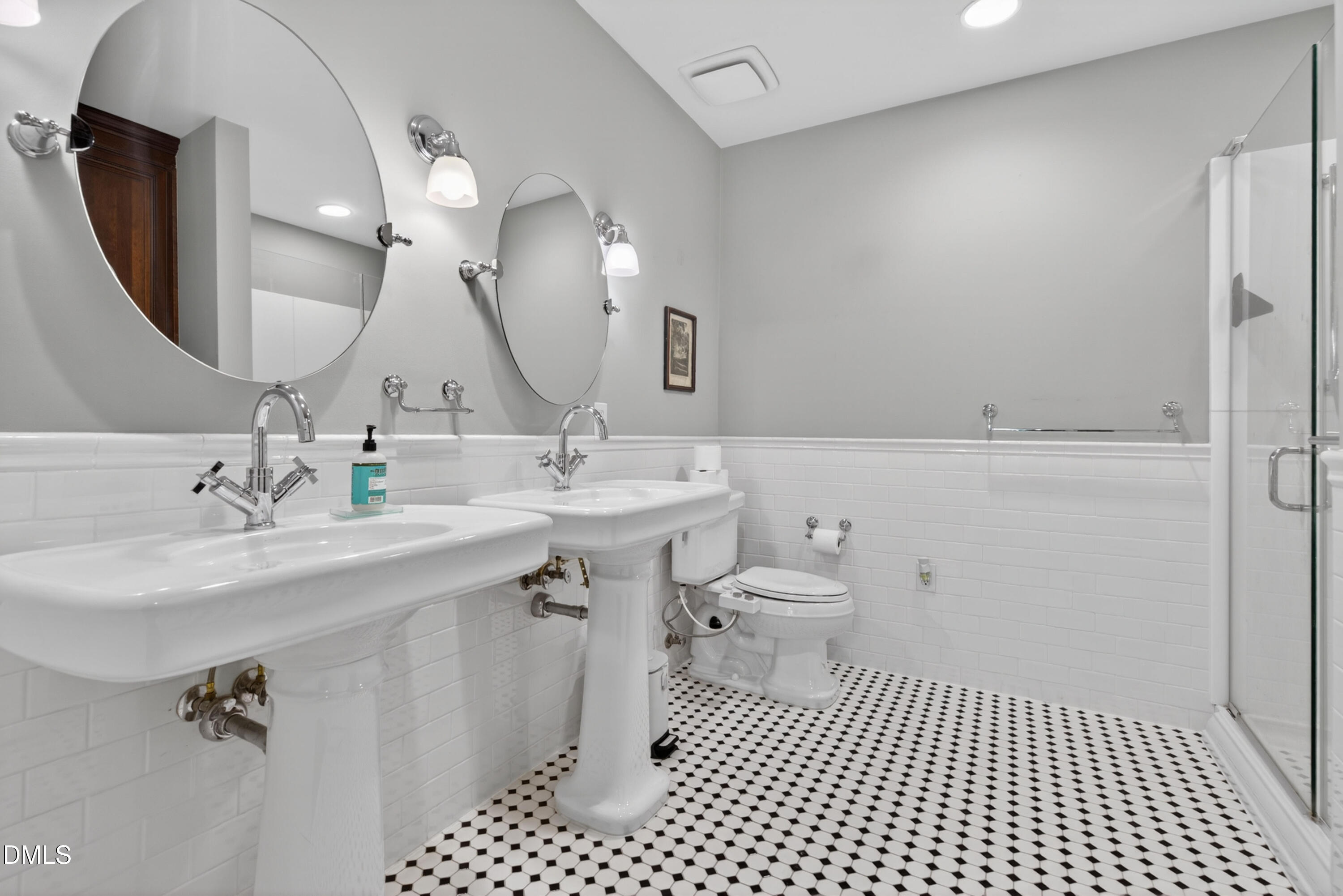710 Independence Place, Unit 104 Raleigh, NC 27603 - Photo 19 of 34 a bathroom with a sink a toilet and a mirror