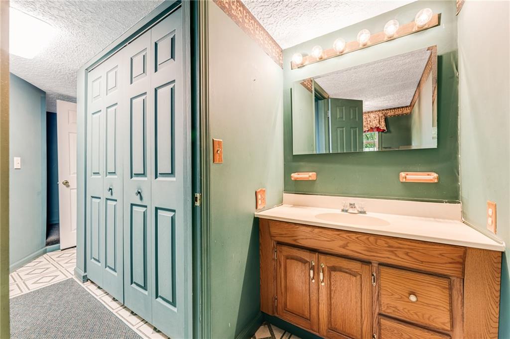 154 Hobbs Run Road Mount Morris, PA 15349 - Photo 20 of 32 a bathroom with a sink a mirror and a shower