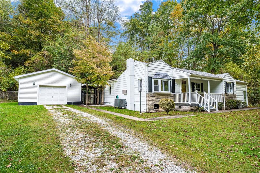 154 Hobbs Run Road Mount Morris, PA 15349 - Photo 26 of 32 a front view of a house with a yard and trees