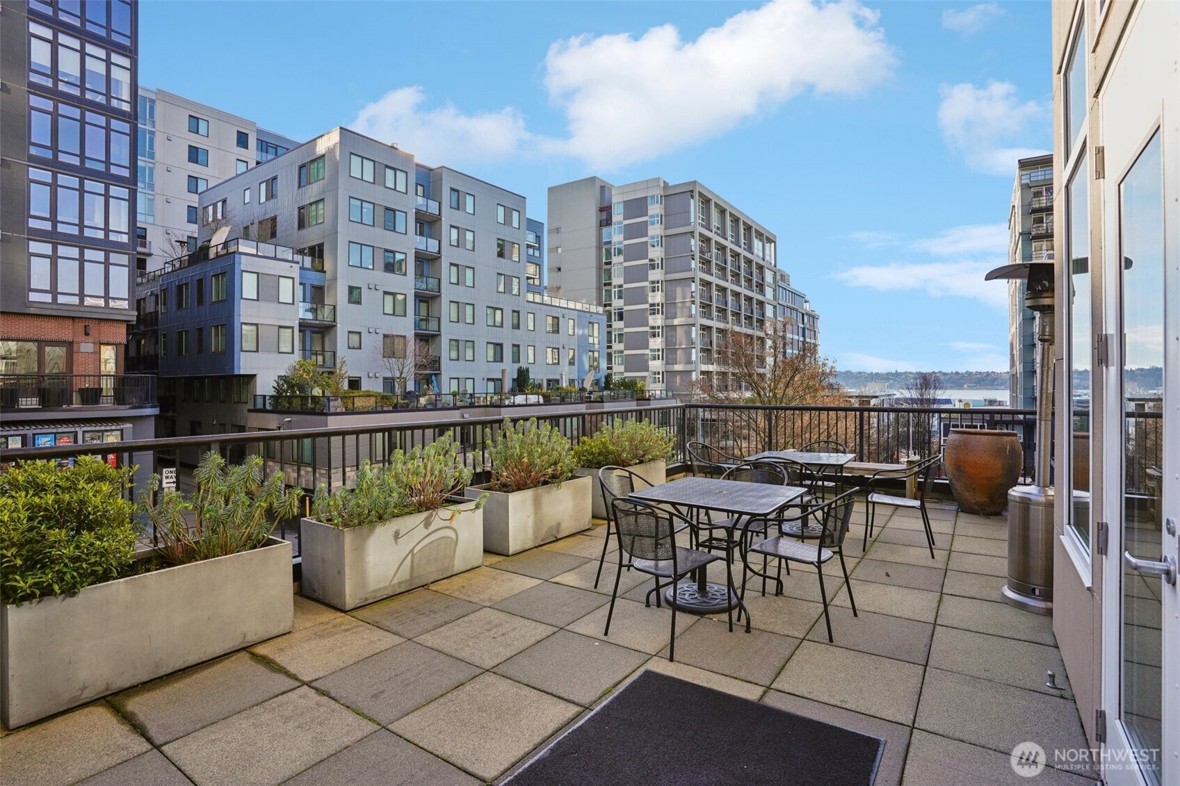 2801 1st Avenue, Unit 615 Seattle, WA 98121 - Photo 18 of 22 a roof deck with patio and outdoor seating