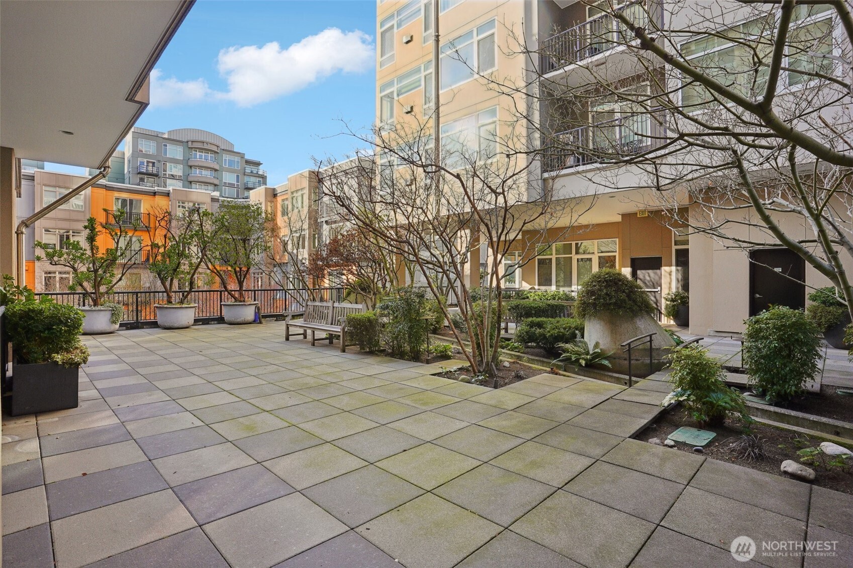 2801 1st Avenue, Unit 615 Seattle, WA 98121 - Photo 20 of 22 a view of a building with a bench in front of it