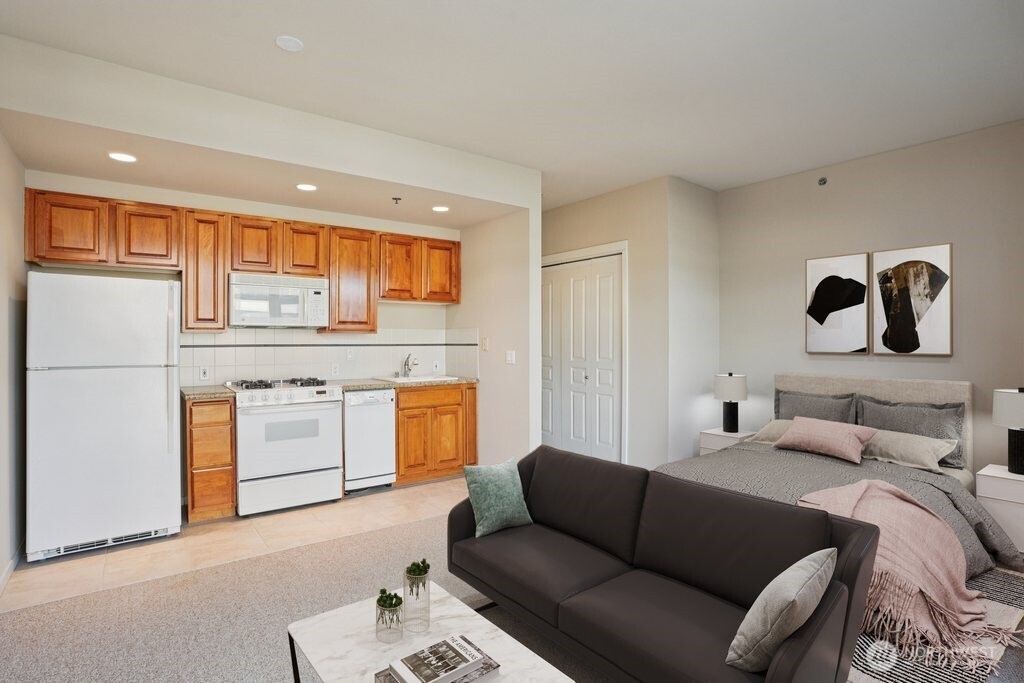 2801 1st Avenue, Unit 615 Seattle, WA 98121 - Photo 4 of 22 a living room with furniture and a kitchen