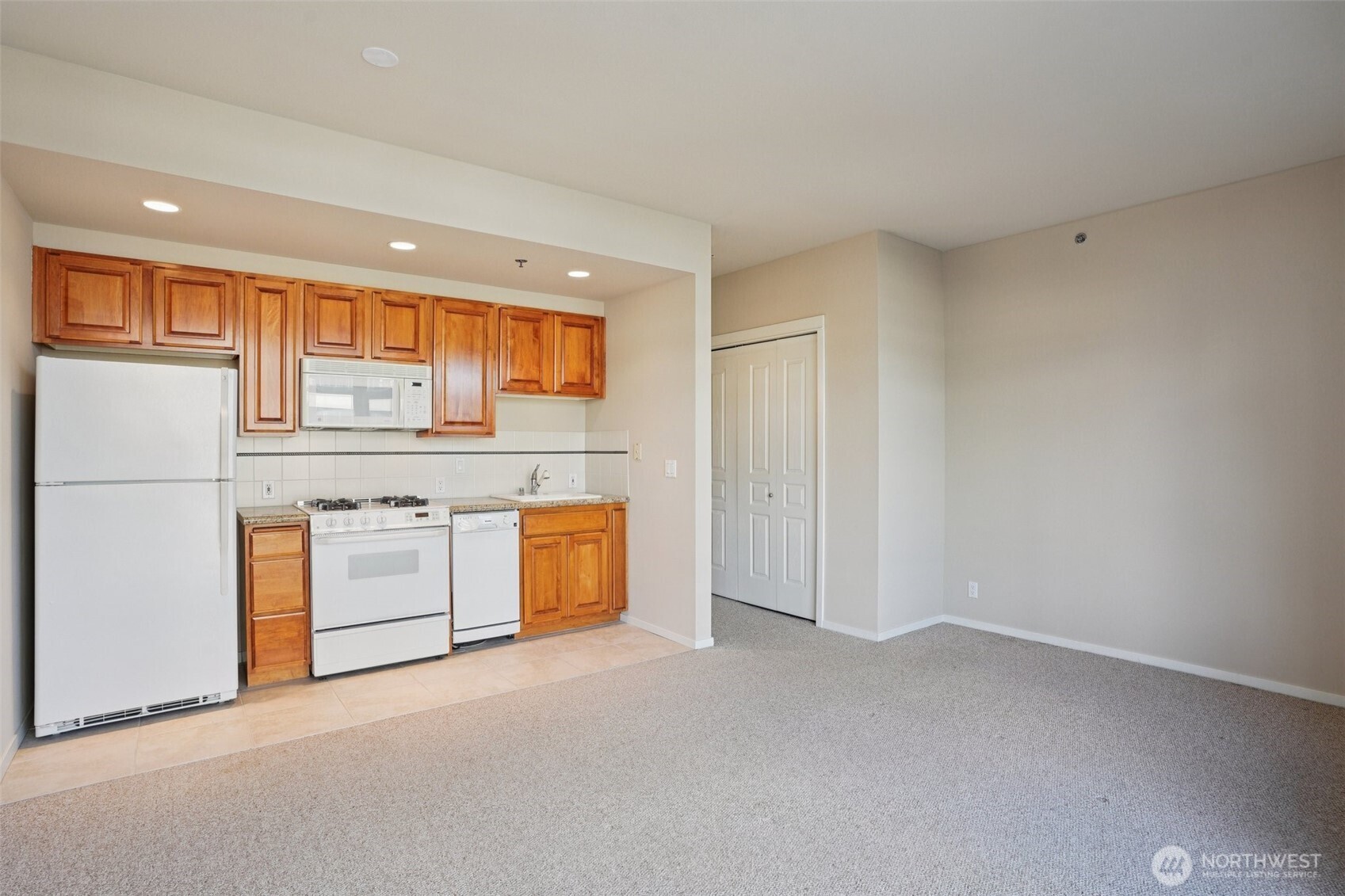 2801 1st Avenue, Unit 615 Seattle, WA 98121 - Photo 5 of 22 a view of kitchen with stainless steel appliances granite countertop cabinets and wooden floor