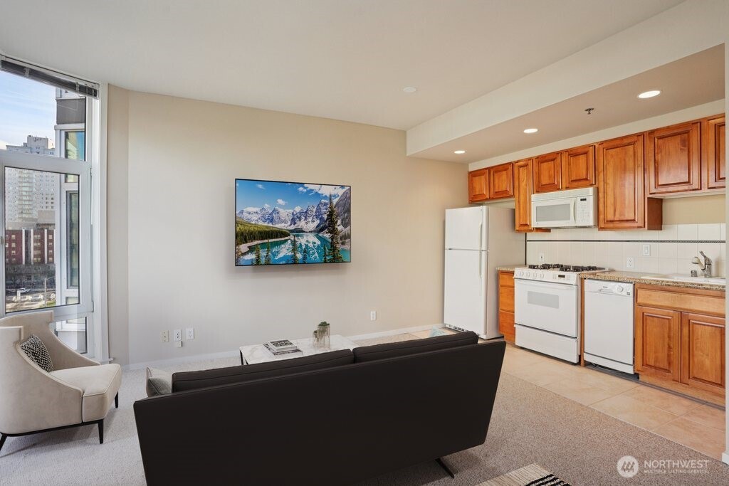 2801 1st Avenue, Unit 615 Seattle, WA 98121 - Photo 7 of 22 a living room with furniture and a flat screen tv