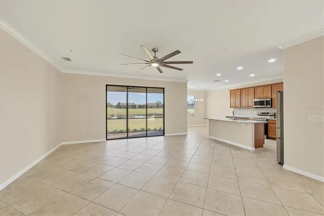 a kitchen with stainless steel appliances granite countertop a refrigerator sink and stove