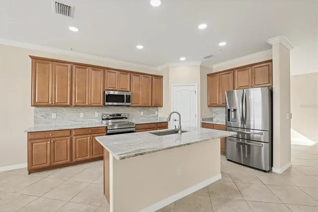 a kitchen with stainless steel appliances granite countertop a sink stove and microwave