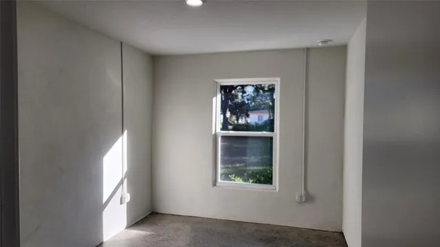 an empty room with windows and closet
