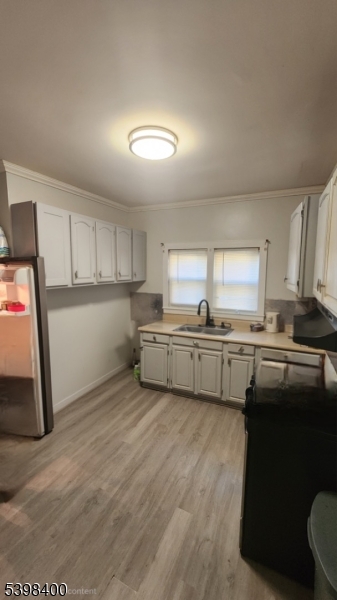 83 Vassar Avenue Newark, NJ 07112 - Photo 6 of 11 a kitchen with stainless steel appliances a refrigerator and a sink