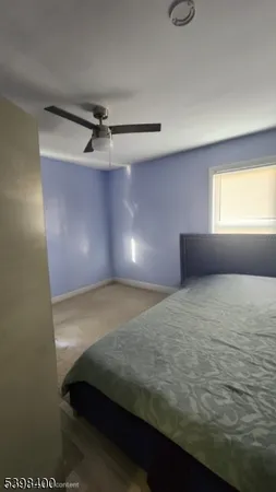 a living room with furniture a rug and a large window