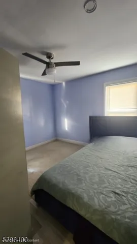 a living room with furniture a rug and a large window
