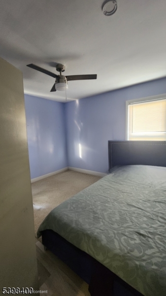83 Vassar Avenue Newark, NJ 07112 - Photo 7 of 11 a bedroom with a bed and a window