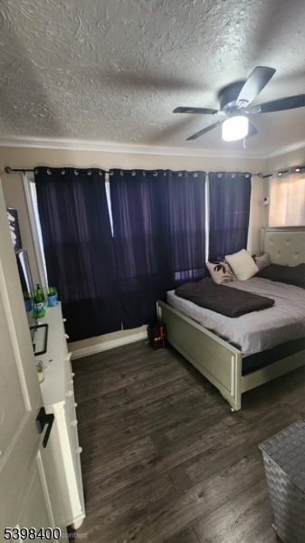 83 Vassar Avenue Newark, NJ 07112 - Photo 10 of 11 a bedroom with a bed and a dresser