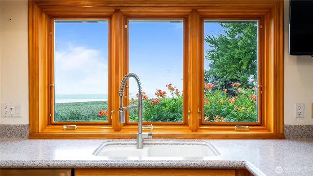 a view of a porch with a floor to ceiling window and outside view