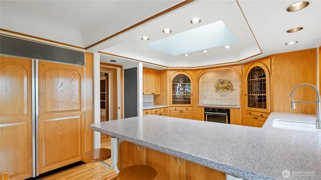 a kitchen with stainless steel appliances granite countertop a refrigerator a stove top oven and sink