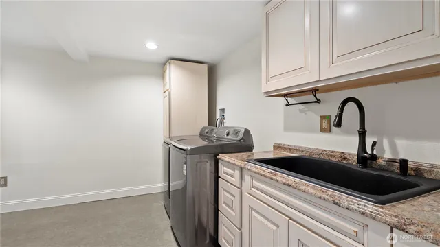 a kitchen with a sink and cabinets