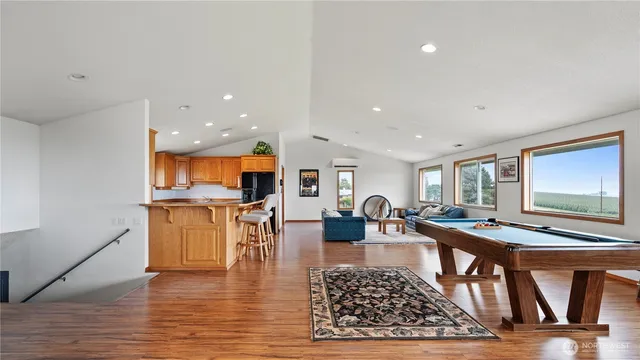 a living room with dining room and wooden floor