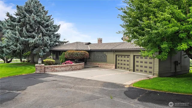 a view of a house with a yard and tree s