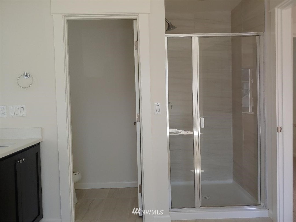4422 185th Place Southeast Bothell, WA 98012 - Photo 15 of 28 a bathroom with a glass shower door