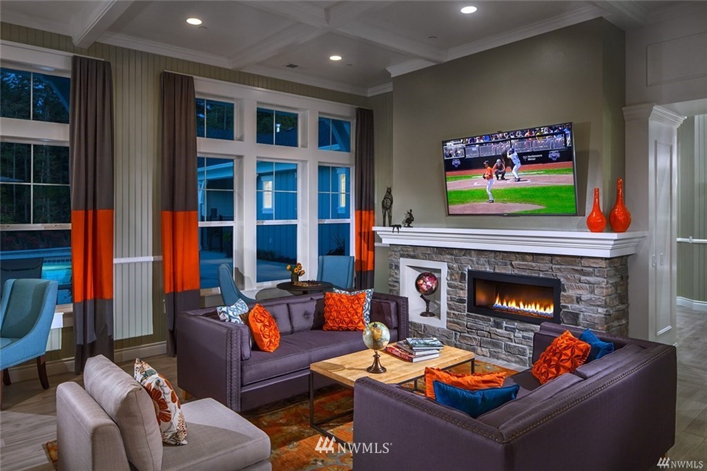 4422 185th Place Southeast Bothell, WA 98012 - Photo 25 of 28 a living room with furniture a flat screen tv and a fireplace
