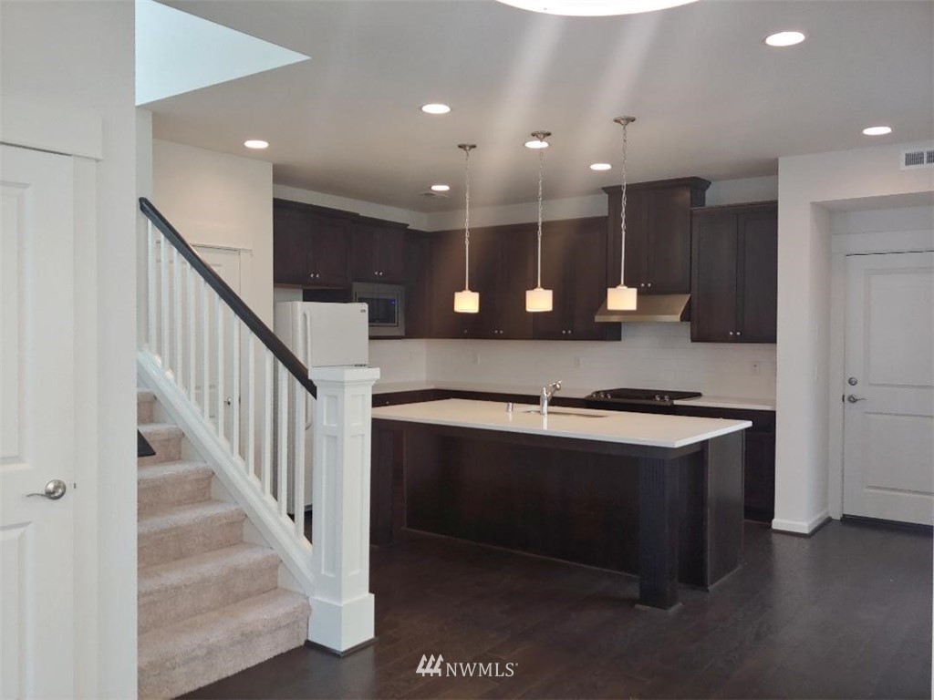 4422 185th Place Southeast Bothell, WA 98012 - Photo 4 of 28 a view of kitchen with kitchen island a sink and a stove