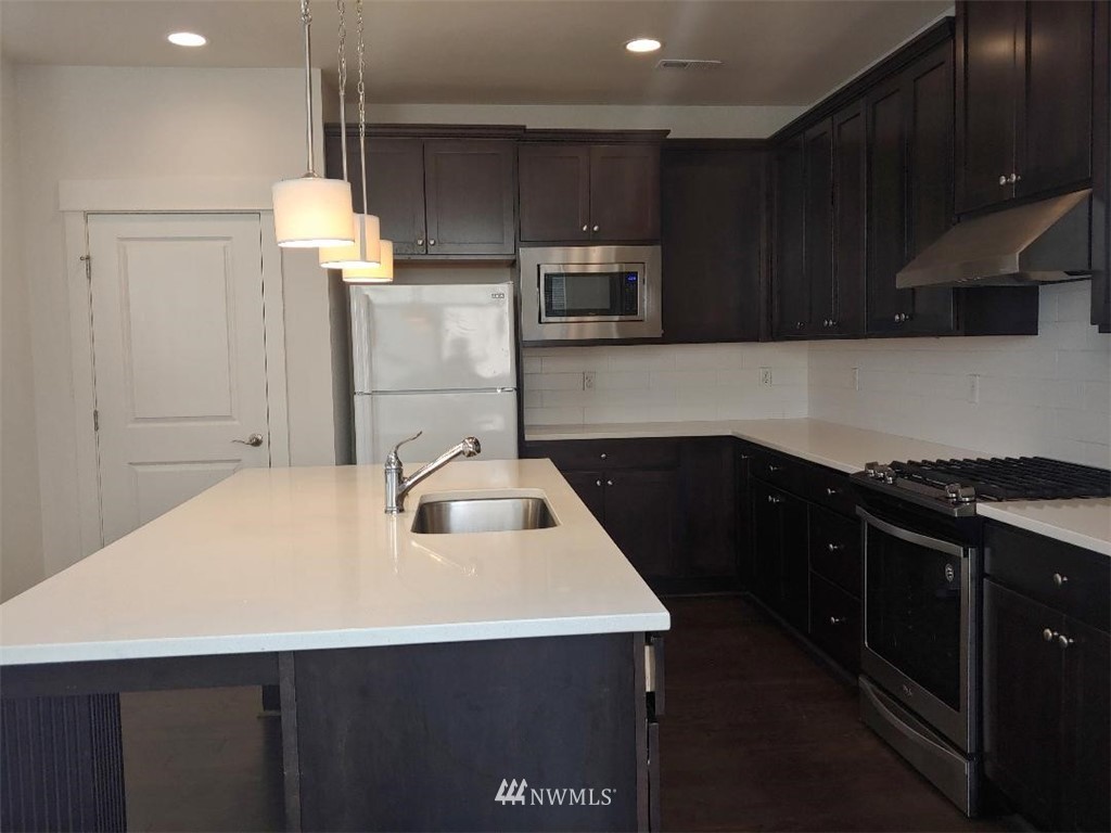 4422 185th Place Southeast Bothell, WA 98012 - Photo 6 of 28 a kitchen with kitchen island a sink stainless steel appliances and cabinets