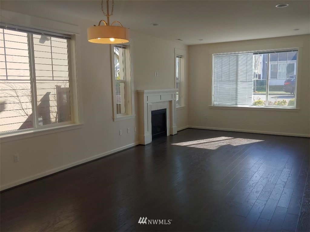 4422 185th Place Southeast Bothell, WA 98012 - Photo 9 of 28 an empty room with wooden floor and windows