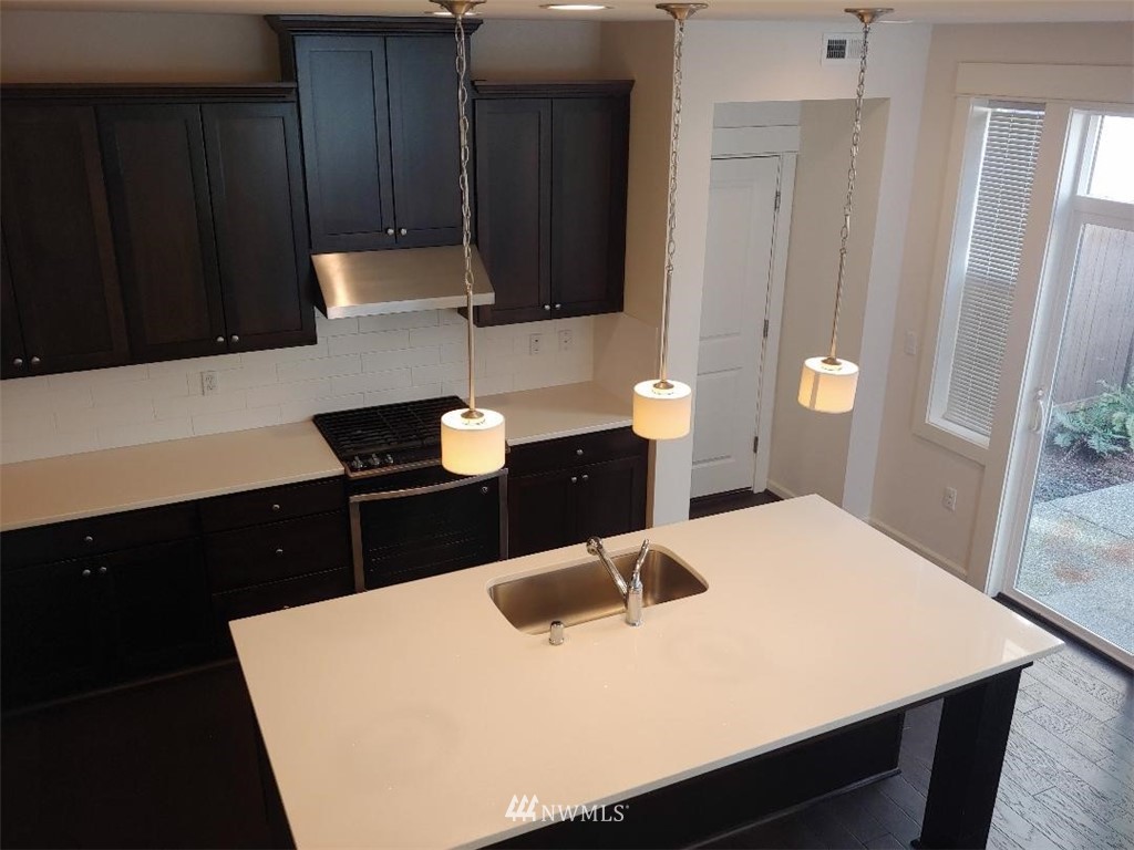 4422 185th Place Southeast Bothell, WA 98012 - Photo 10 of 28 a kitchen with a wooden table and chairs
