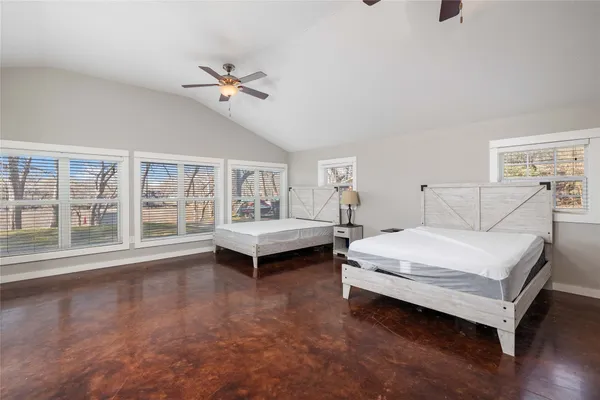 a spacious bedroom with a bed and a large window