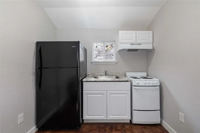 a utility room with cabinets washer and dryer