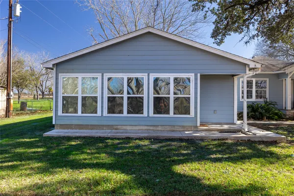 a view of house with backyard