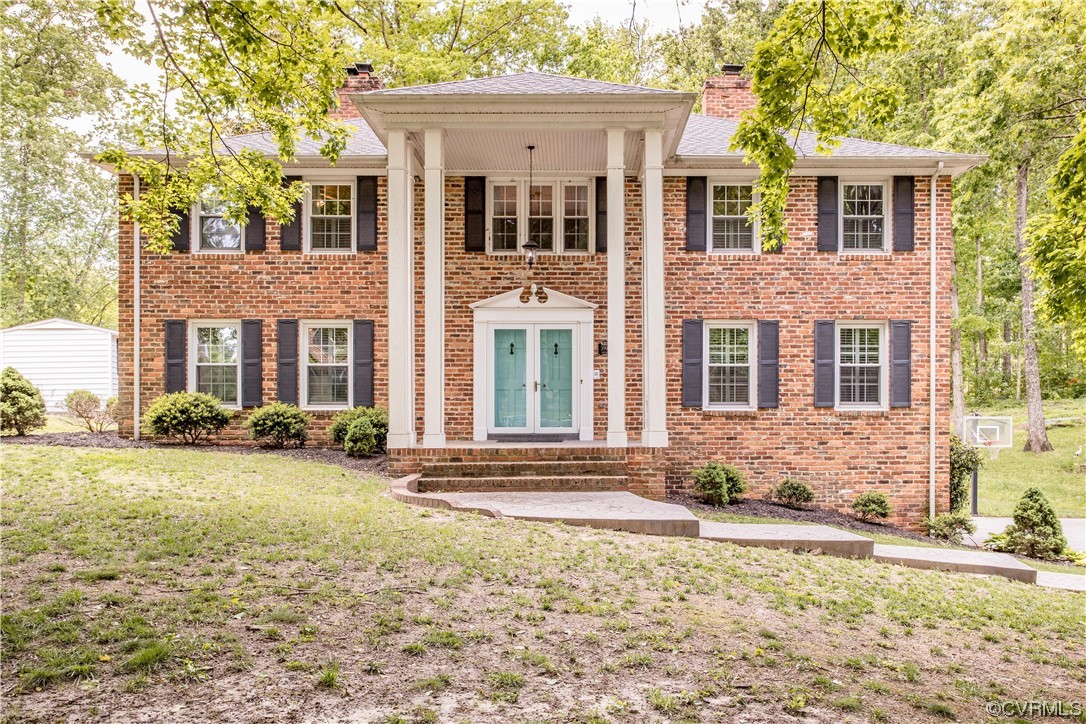 3911 Cresthill Road Chester, VA 23831 - Photo 1 of 50 front view of a brick house with a yard