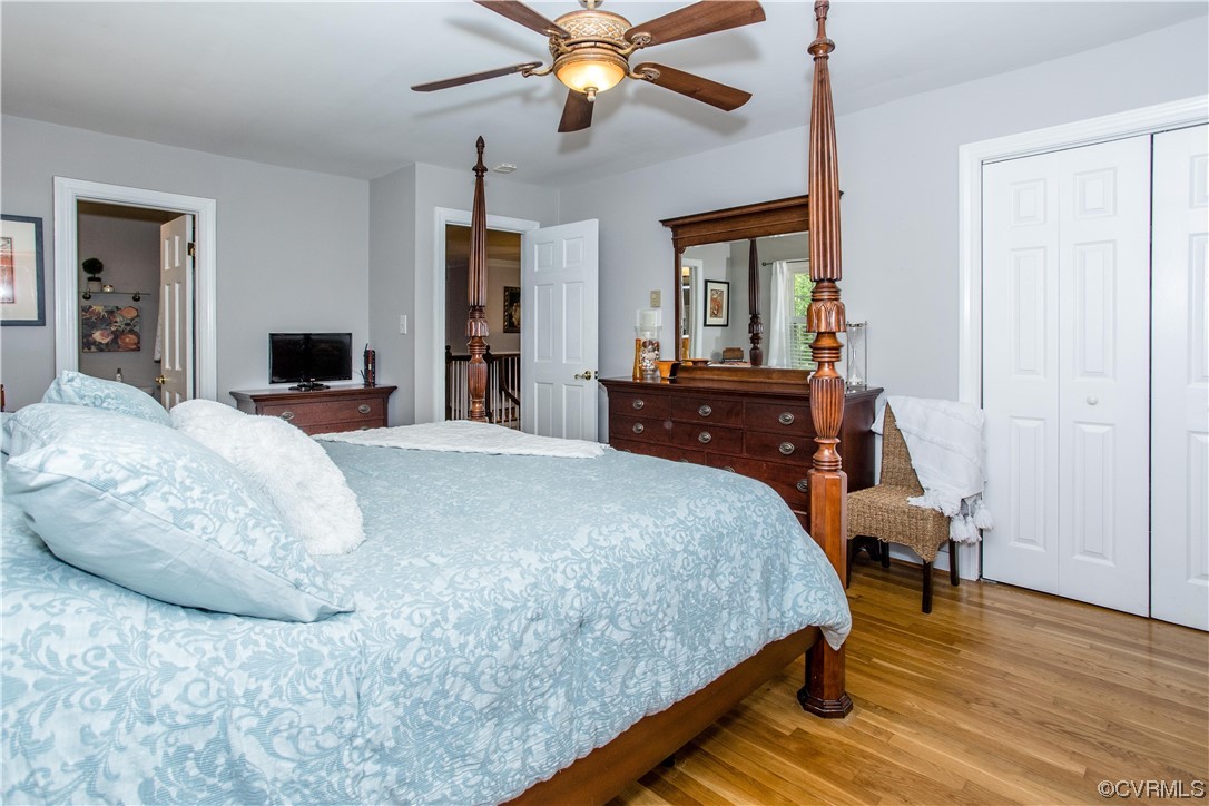 3911 Cresthill Road Chester, VA 23831 - Photo 17 of 50 a bedroom with a large bed and a chandelier