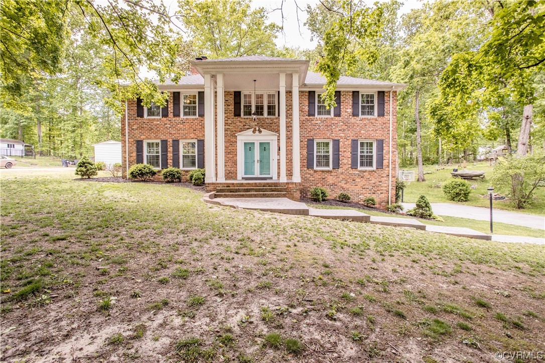 3911 Cresthill Road Chester, VA 23831 - Photo 3 of 50 a front view of a house with a yard