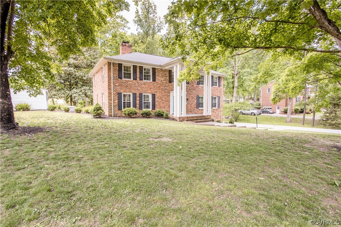3911 Cresthill Road Chester, VA 23831 - Photo 4 of 50 a front view of a building with a yard