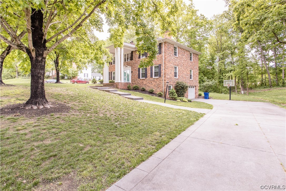 3911 Cresthill Road Chester, VA 23831 - Photo 5 of 50 a front view of a house with a yard and trees