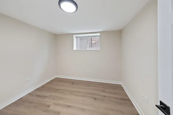 a view of a room with wooden floor and window