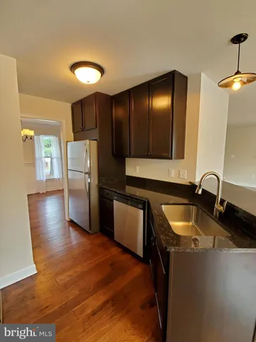 a kitchen with wooden cabinets and stainless steel appliances