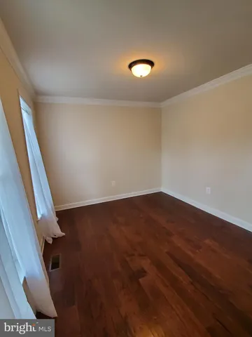 an empty room with wooden floor
