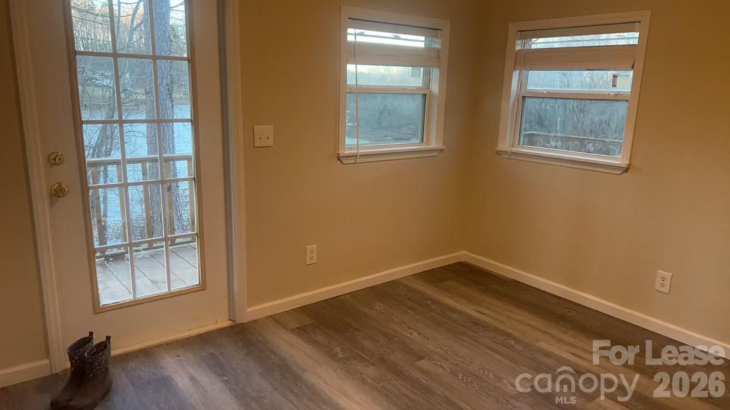 118 Fisherman Cove Road Belmont, NC 28012 - Photo 12 of 12 a view of an empty room with wooden floor and a window