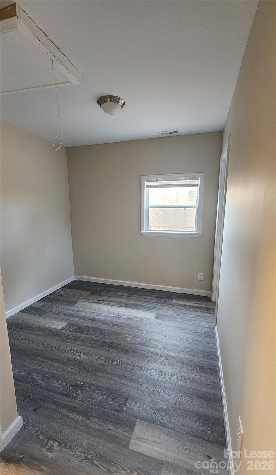 118 Fisherman Cove Road Belmont, NC 28012 - Photo 6 of 12 an empty room with wooden floor and windows