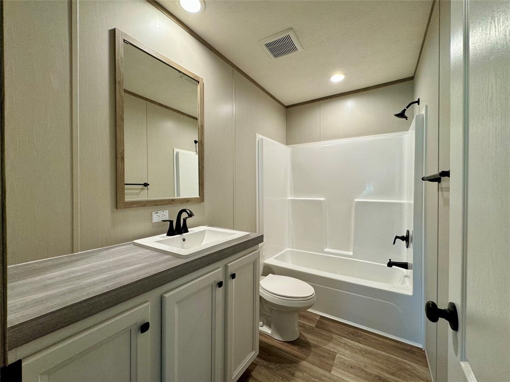 706 Sandpiper Circle Seven Points, TX 75143 - Photo 21 of 22 a bathroom with a sink a toilet and shower