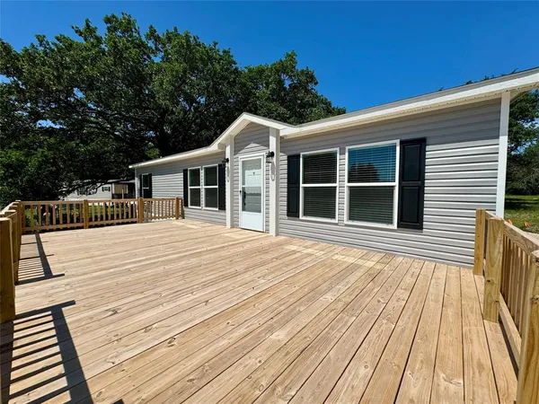 a view of a house with pool and wooden floor