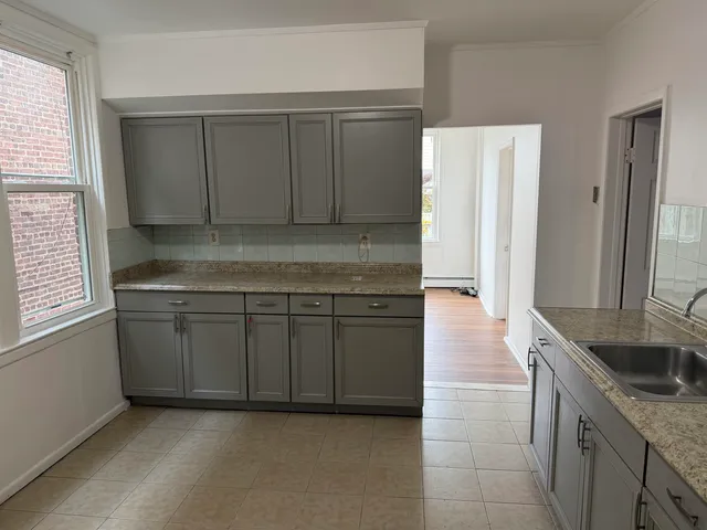 a kitchen with a sink and cabinets