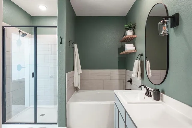 a bathroom with a sink vanity granite and a mirror