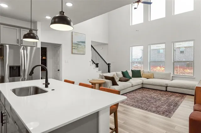 a living room with furniture and a chandelier