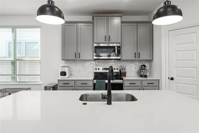 a kitchen with stainless steel appliances granite countertop a stove and cabinets